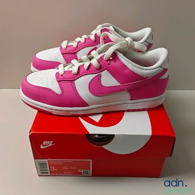 pink and white nike dunk dunk low sneakers on top of a box