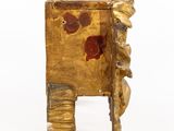 a small gold box with a red flower on it