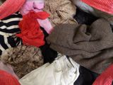 a pile of clothes in a bag on the floor
