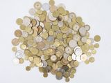 a pile of coins sitting on top of a white surface