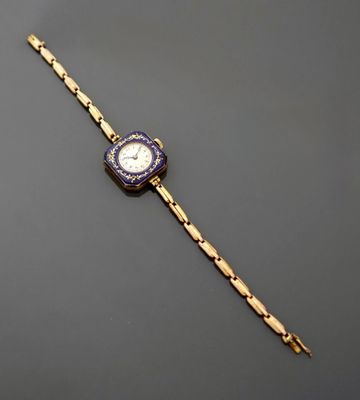 a gold and enamel wrist watch with a blue dial