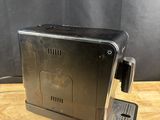an old coffee machine sitting on top of a wooden table