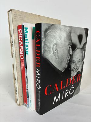 two books are stacked on top of each other on a white surface