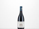 a bottle of red wine sitting on top of a table