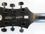 a close up of a guitar neck with a lot of knobs on it