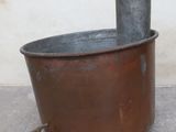 a large metal tub with a faucet on the side of it
