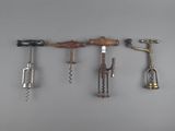 four different types of cork openers hanging on a wall