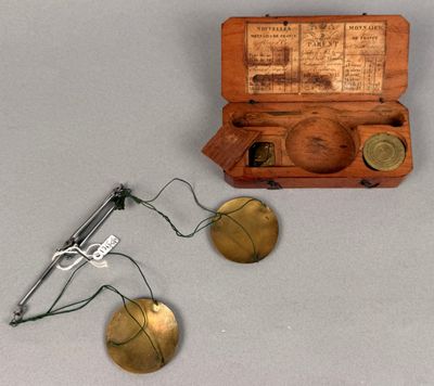 a small wooden box with a pair of scissors next to it