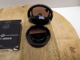 a box of makeup sitting on a table next to a box of powder