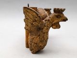 a wooden sculpture of a bird with a crown on it ' s head
