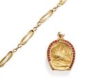 a close up of a gold chain with a coin on it