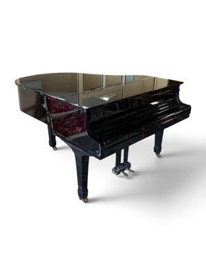 a grand piano that is sitting on a white surface