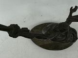a metal object on the wall with a knife in it