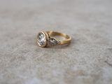 an image of a gold ring with two diamonds on it