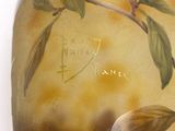 a vase with a painting on it on a table