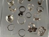 many different rings in a clear box on a table