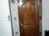 a tall wooden cabinet in the corner of a room