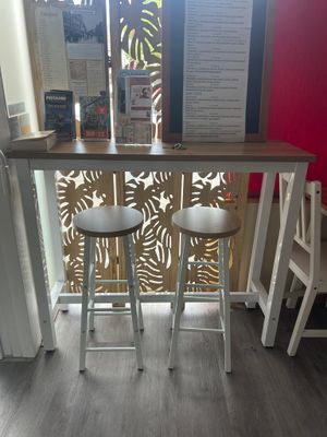 two stools in front of a counter in a restaurant