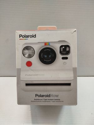 a polaroid camera sitting on top of a box