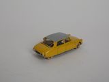 a yellow toy car that is sitting on a white surface