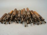 a pile of wooden dows on a white surface