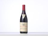 a bottle of red wine sitting on top of a table