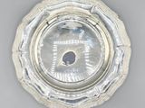 an image of a silver plate with a diamond in the center