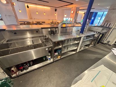 a large stainless steel sink in the middle of a kitchen
