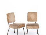 pair of mid - century style chairs with upholstered cushions