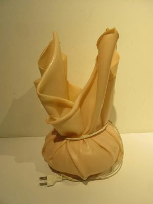 a vase with a cloth wrapped around it sitting on a table