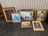 some of the paintings are sitting on the floor next to each other