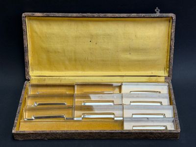 four knives in a wooden case on a black background