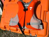 two orange life vests sitting on top of an orange case