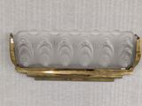a close up of a glass candle holder on a wall
