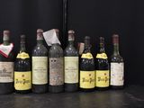 several bottles of wine are lined up on a table