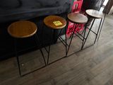 three stools that are sitting in front of a bar