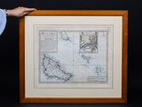 Une vieille carte des îles britanniques est exposée dans un cadre en bois.