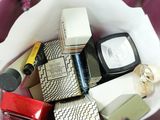 a white bowl filled with various types of cosmetics