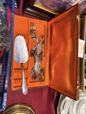 an orange case with a silver spoon and a fork inside of it
