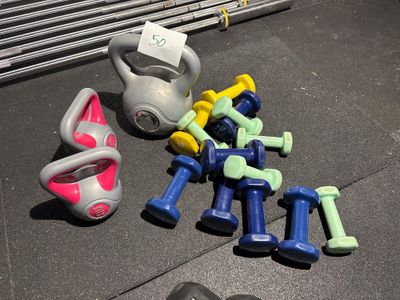 plein d'haltères et un kettlebell par terre