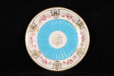 a blue and white plate with pink flowers on it