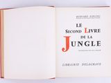 an open book on a white surface with a red cover