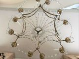 a chandelier hanging from the ceiling in a living room