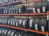 tires are stacked on shelves in a warehouse with a lot of them