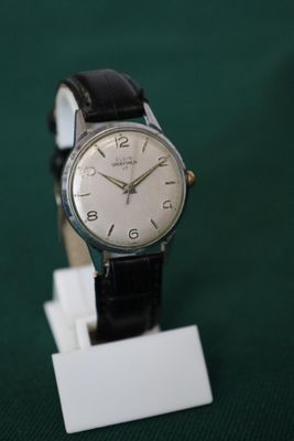 a watch that is sitting on a stand on a table