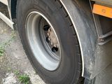 a truck with a flat tire parked on the side of the road