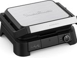 an image of a black and silver sandwich maker on a white background