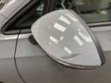 a reflection of a person in the side mirror of a car