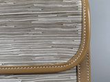 a close up of a purse with a strap on it