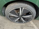 a close up of a tire on a green car